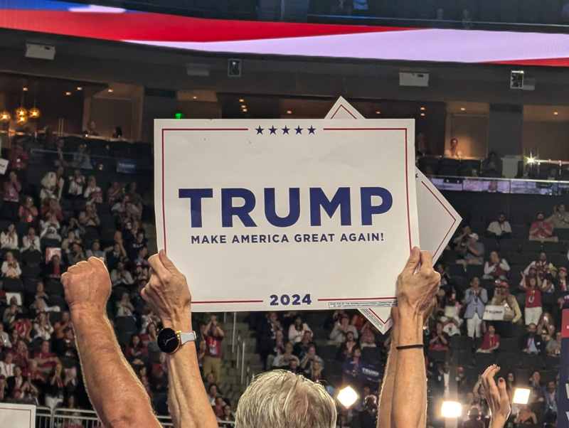 2024 RNC Convention attendee holds Trump sign