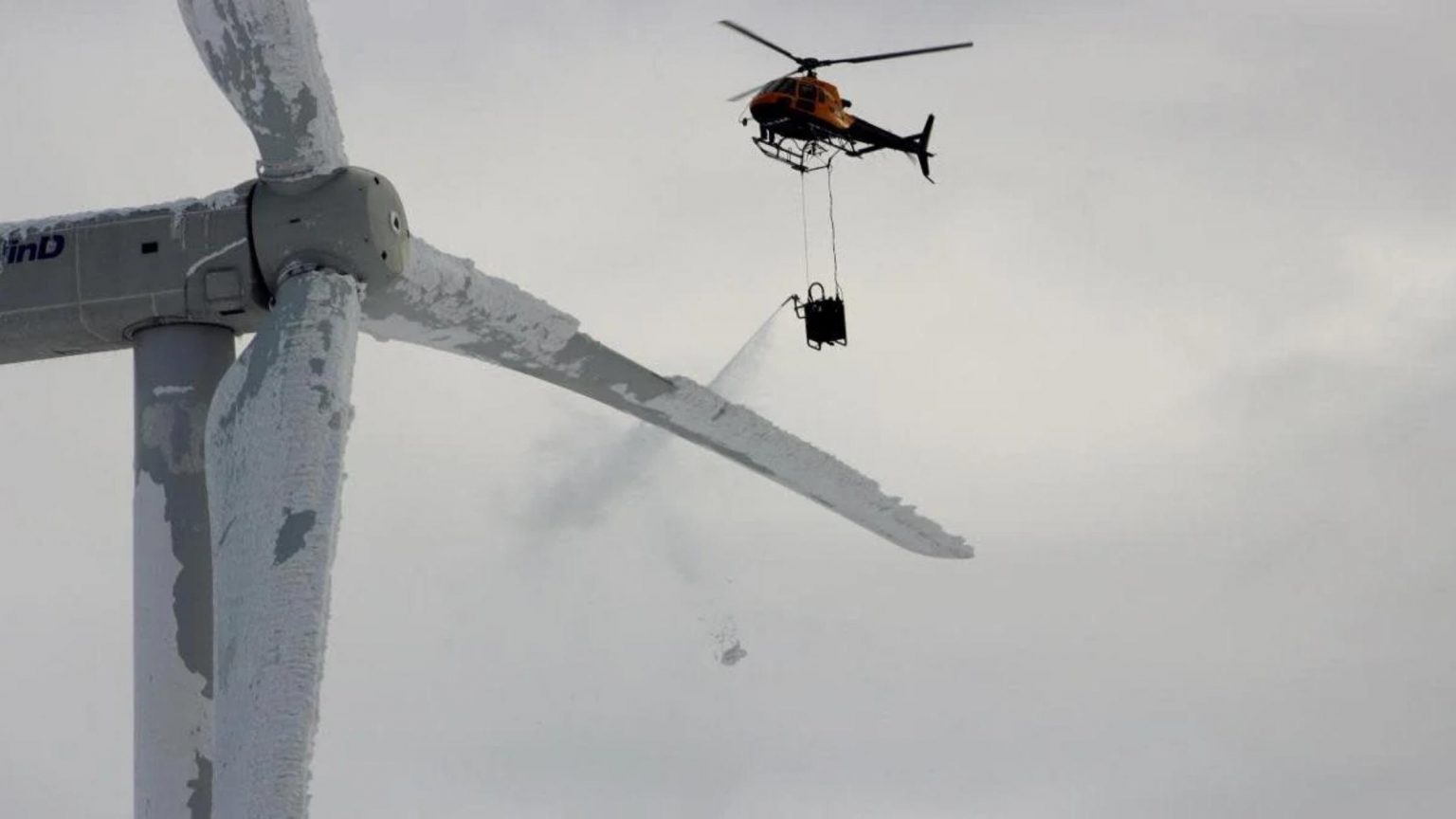 Helicopter attempts to de-ice turbine blade on Swedish wind turbine.