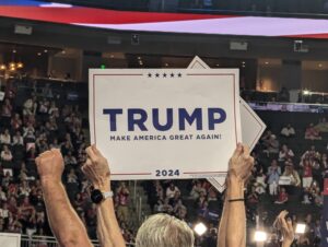 2024 RNC Convention attendee holds Trump sign